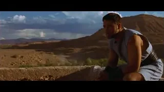 man sitting on stone wall desert landscape — Gladiator