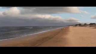 sandy beach with red cars parked — Cars 3