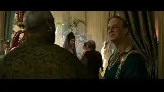 man in green robe and crown conversing — Gladiator 2