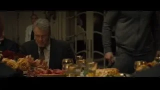 man in suit sitting at dining table — Creed 2