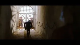people in medieval clothing walking stone corridor — Gladiator