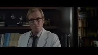 Man in lab coat sitting, deep in thought — The Amazing Spider Man