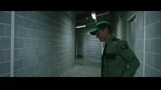 man walking down long gray hallway — Now You See Me 2