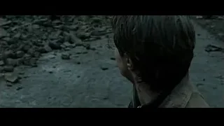 young man in brown jacket in rocky landscape — Harry Potter and the Deathly Hallows 2