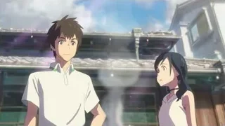 young man and woman at large building — Weathering with You