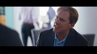 man in suit sitting in office — The Big Short