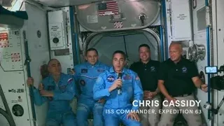 astronauts speaking into microphone in space station — Elon Musk: Return to Space