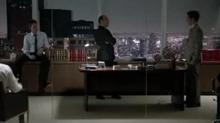 three men in office with city skyline — Suits