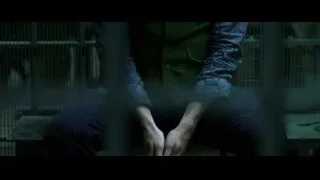 Joker standing in dark room with cage — Batman: The Dark Knight