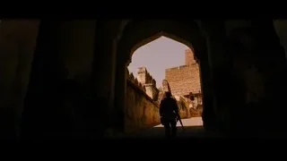 person walking through stone archway — Batman: The Dark Knight Rises