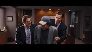 man in suit sitting in office — The Wolf Of Wall Street