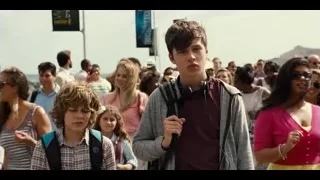 young man standing in street crowd — Jurassic World