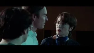 Woman speaking to man in dimly lit room — Steve Jobs