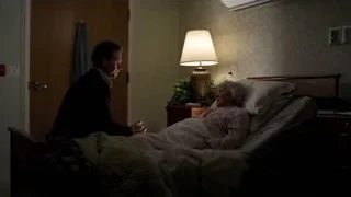 man comforting elderly woman in hospital bed — Suits