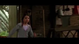young girl standing by brick wall — Batman