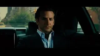 man in suit sitting in car on street — Limitless