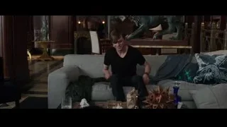 Young man in living room with dragon statue — The Amazing Spider Man 2