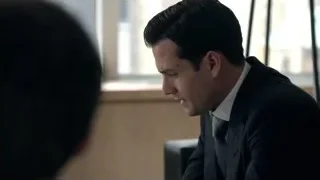 man in suit sitting at desk deep in thought — Suits