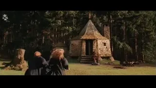 Two people near stone building — Harry Potter and the Philosophers Stone