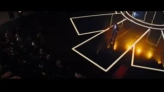 man in suit performing on stage to crowd — Now You See Me
