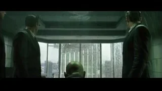 Men looking out window at rainy cityscape — The Matrix