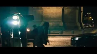 Person next to motorcycle on street at night — John Wick: Chapter 4