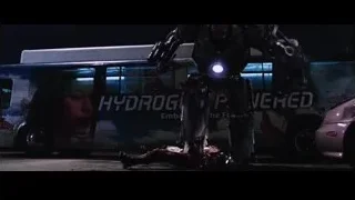 robot standing in front of a bus — Iron Man