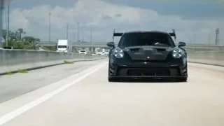 black sports car driving on race track — Sports Cars