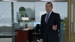 Man in suit in office with city skyline — Suits