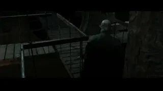 Man standing on staircase in dark stone room — Harry Potter and the Deathly Hallows 2