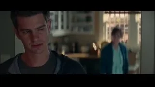 young man looking at phone in dark room — The Amazing Spider Man 2
