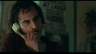 Man holding telephone to ear deep in thought — Joker