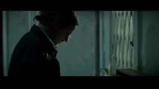 man in dimly lit room with laptop — Limitless