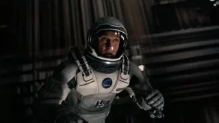 man in space suit in dimly lit spaceship — Interstellar
