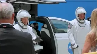 men in spacesuits around white car — Elon Musk: Return to Space