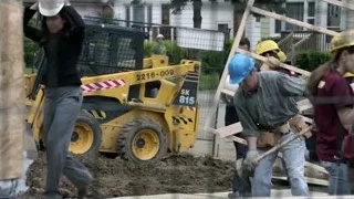 workers and woman at construction site — Suits
