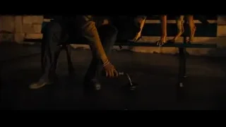 man in brown jacket sitting on bench — John Wick: Chapter 4