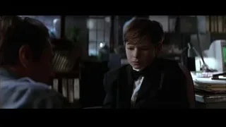 young boy in suit at cluttered desk — Batman