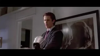 Man in suit holding white helmet — American Psycho