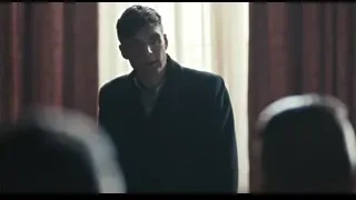 young man standing in dimly lit room with window — Peaky Blinders