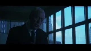 elderly man deep in thought by city window — Batman: The Dark Knight