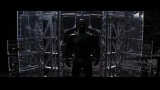 Man in suit by futuristic metal structure — Batman: The Dark Knight Rises