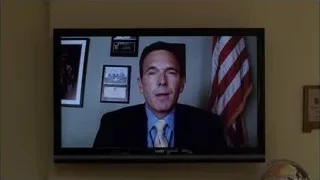 Man in suit on video call with American flag — Breaking Bad