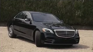 Two black luxury cars on gravel road — Succession