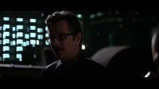 man with mustache standing by grid screen — Batman: The Dark Knight