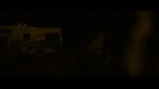person standing in front of caravan at night — Into the Wild