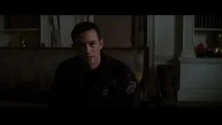 man sitting in dimly lit room — Batman: The Dark Knight Rises