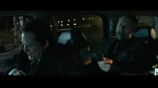 two men in car, one holding gun — John Wick