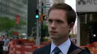 two men in suits in tense conversation — Suits
