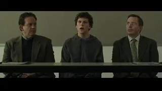 Three men sitting at courtroom table — The Social Network